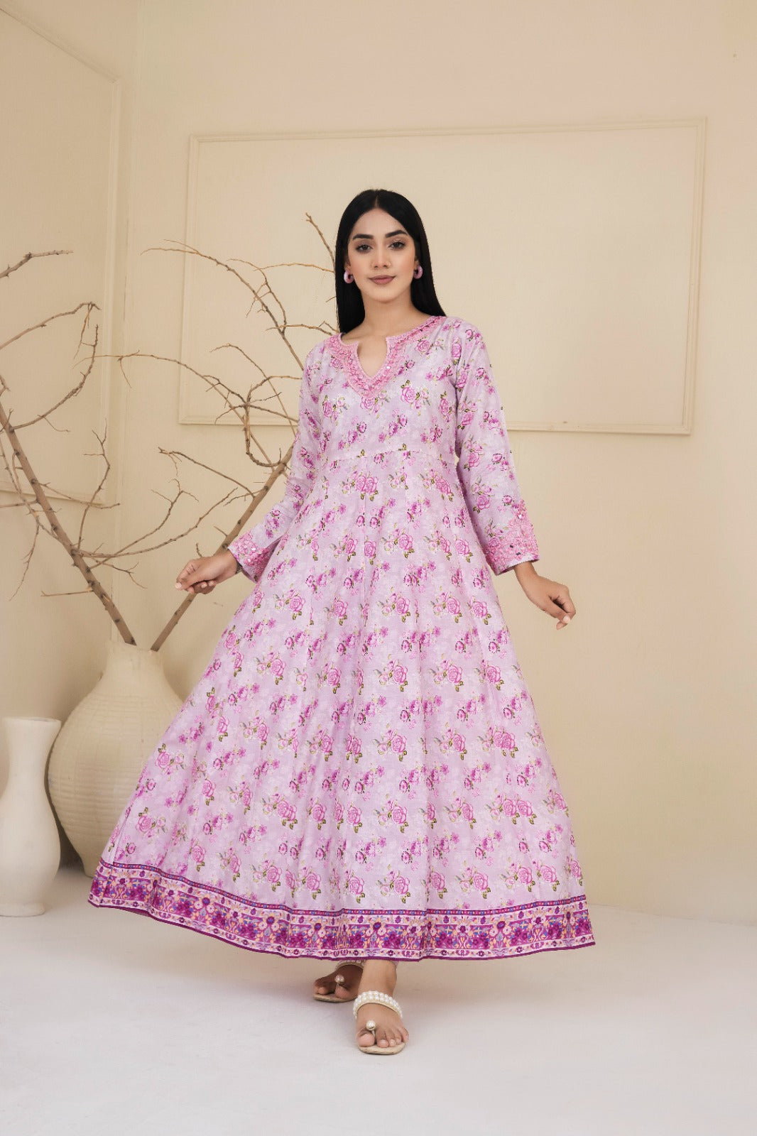 Floral printed pink cotton suit with an intricately embroidered neckline adorned with mirrors complimented by straight leg pants