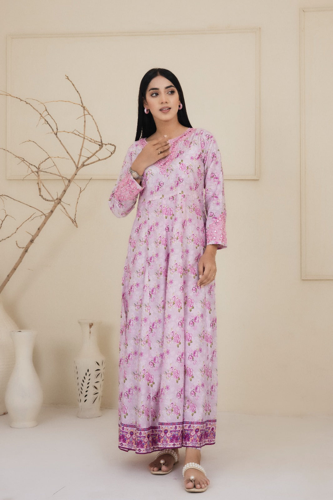 Floral printed pink cotton suit with an intricately embroidered neckline adorned with mirrors complimented by straight leg pants