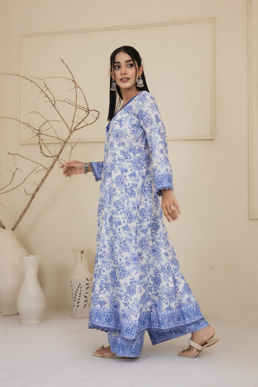 Floral printed blue and white cotton suit with an intricately embroidered neckline complimented by wide leg pants