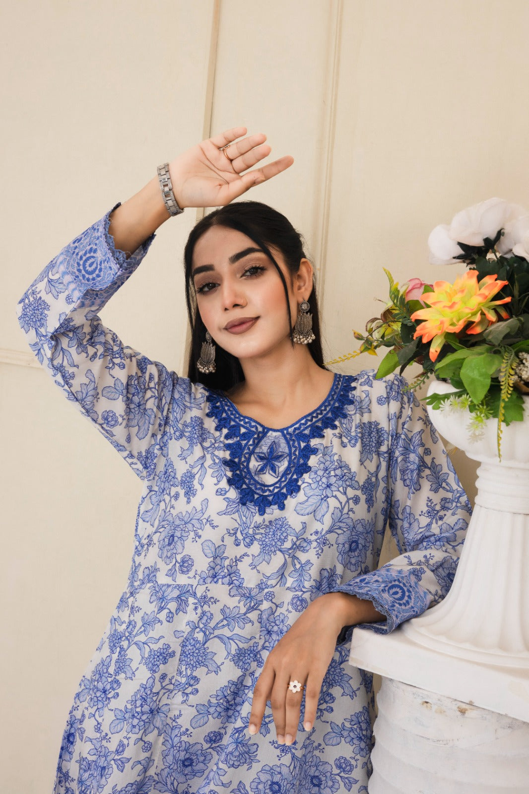 Floral printed blue and white cotton suit with an intricately embroidered neckline complimented by wide leg pants