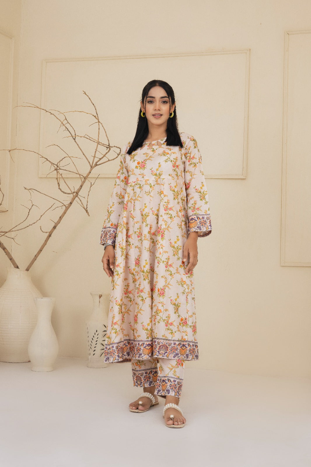 Floral printed cream cotton suit with a keyhole neckline complimented by straight leg pants